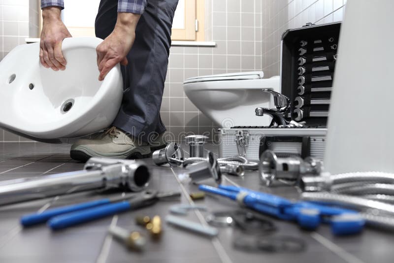 Professional plumber working on residential plumbing installation